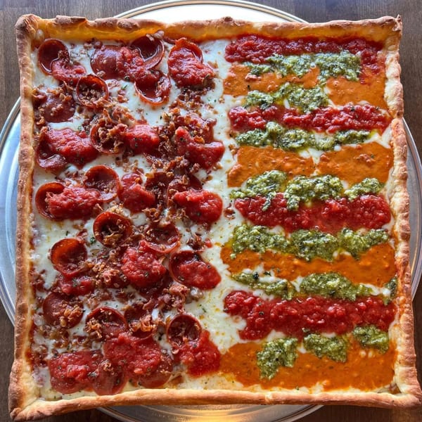 Square PEEL pizza, half with pepperoni and red sauce, half with striped pesto, red, and orange sauces.
